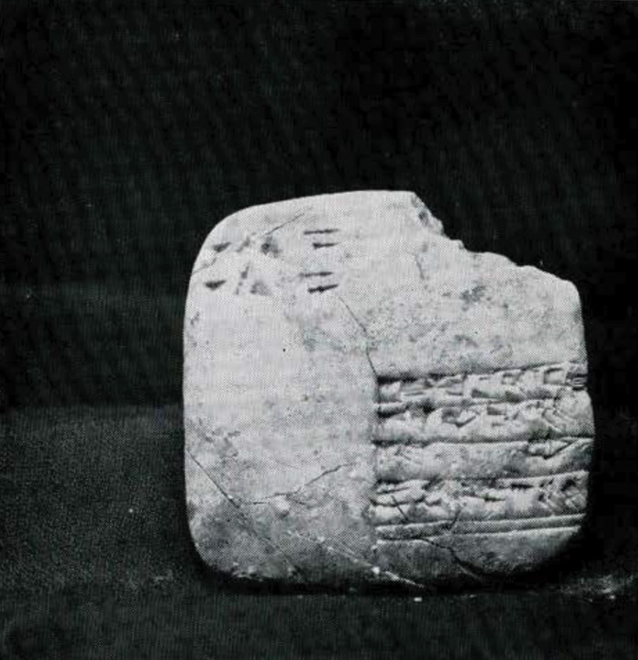 A fragmented square tablet with a few registeres of cuneiform math problems.