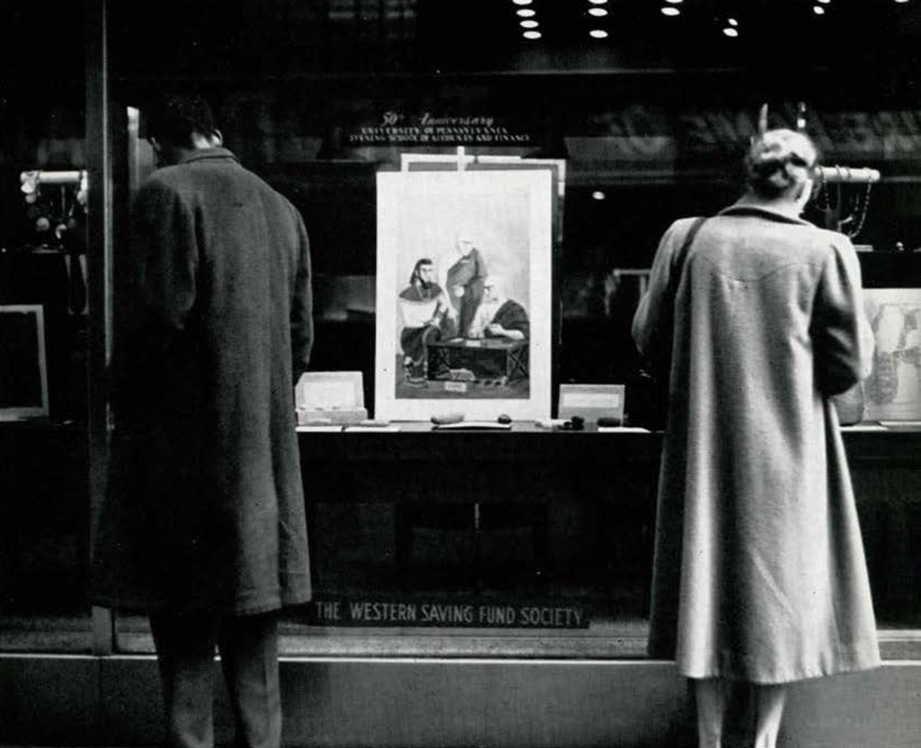 Two people viewing objects in a display case labeled The Western Saving Fund Society.