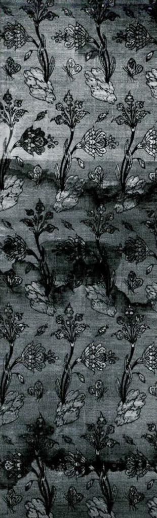 Woven velvet textile with a repeating pattern of lilies growing from rocks and butterflies.