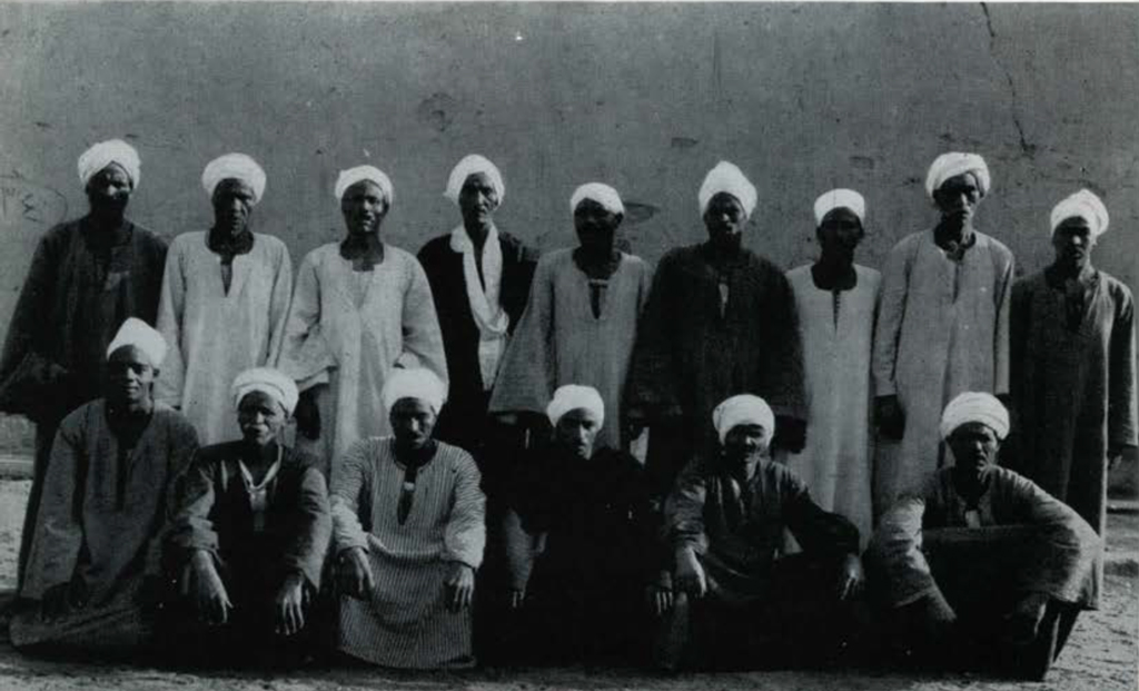 A group portait of fifteen men.