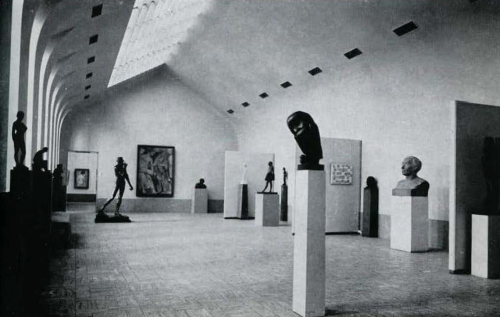 A large gallery with sculptures and statues.
