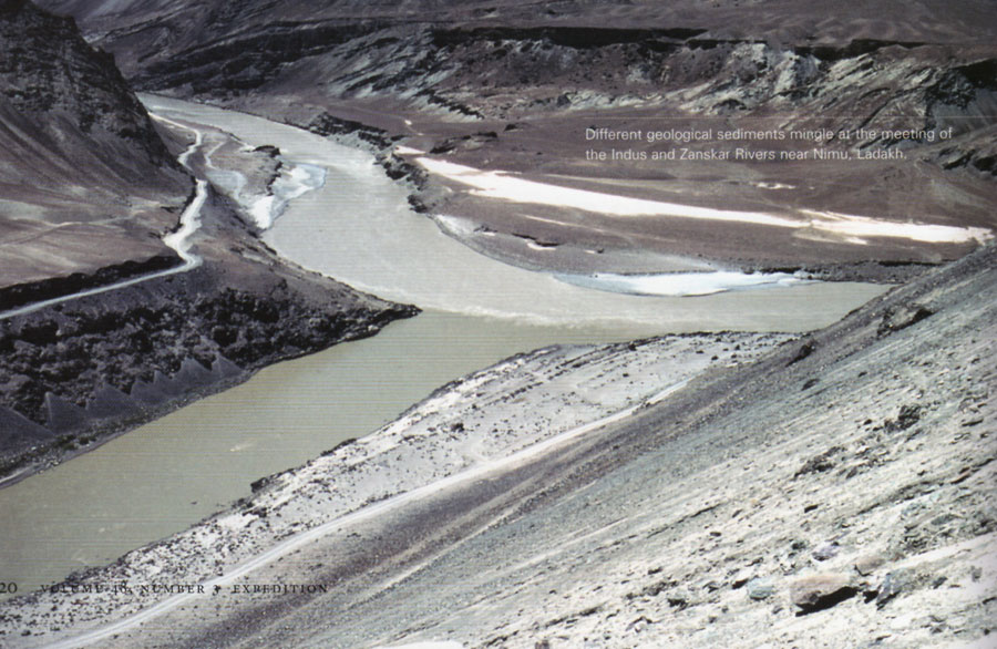 Different colored layers of sediment along the banks of a river.