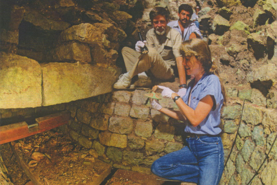 Archaeologists and a conservator excavating a Copan burial tomb.