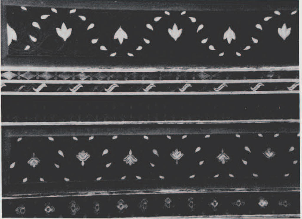 Carved motif of duck shapes in a line.