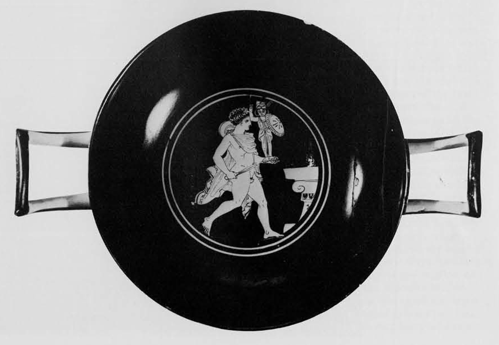 Interior of a kylix showing Diomedes stealling and running away with a small statue of Athena from a pedestal.