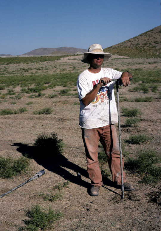 A man with survey equipment in the plains around Gordion.