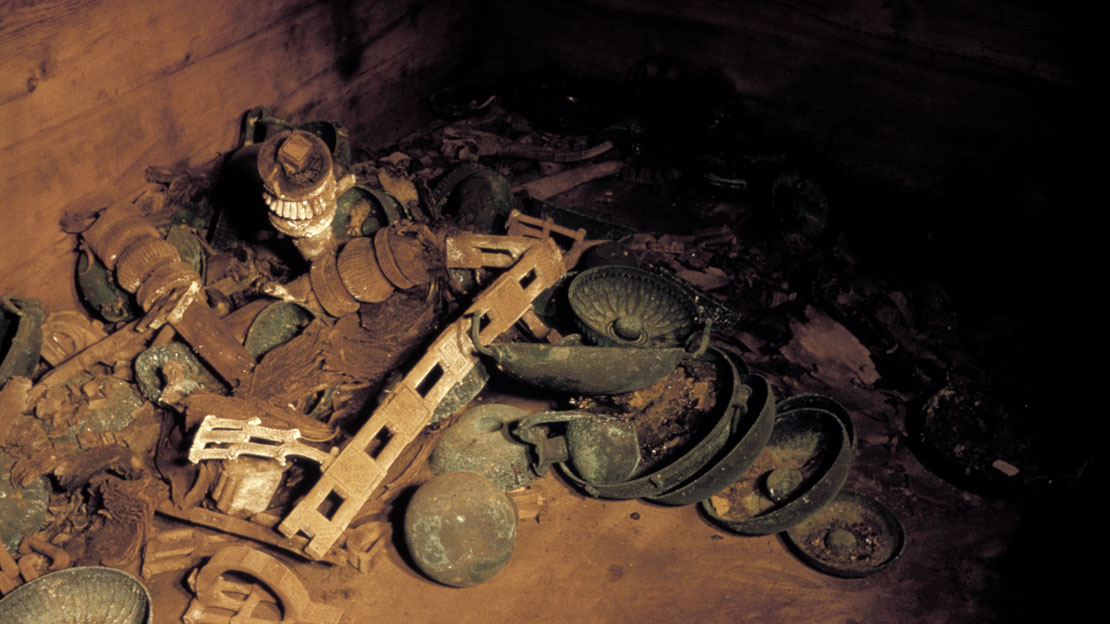 A variety of metal items scattered on the floor, including bowls and pitchers.