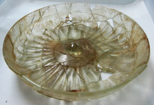 A translucent white class bowl with a radial line pattern.