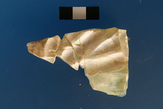 A fragment of glass on a blue background.