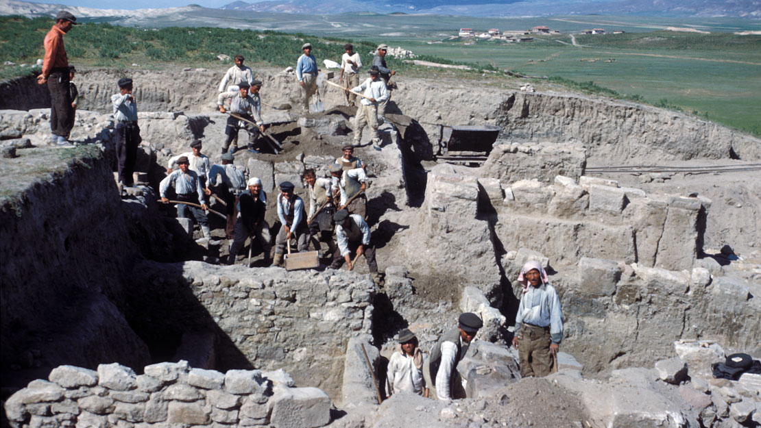 A multilayered excavation at Gordion, people working on the various levels.