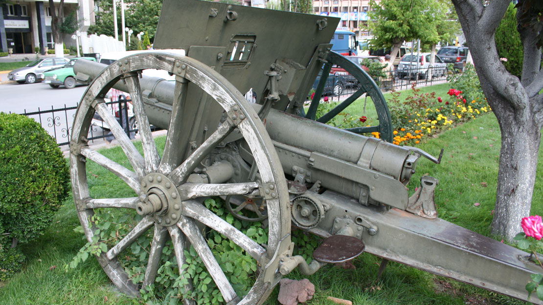 A wheeled cannon in a courtyard.
