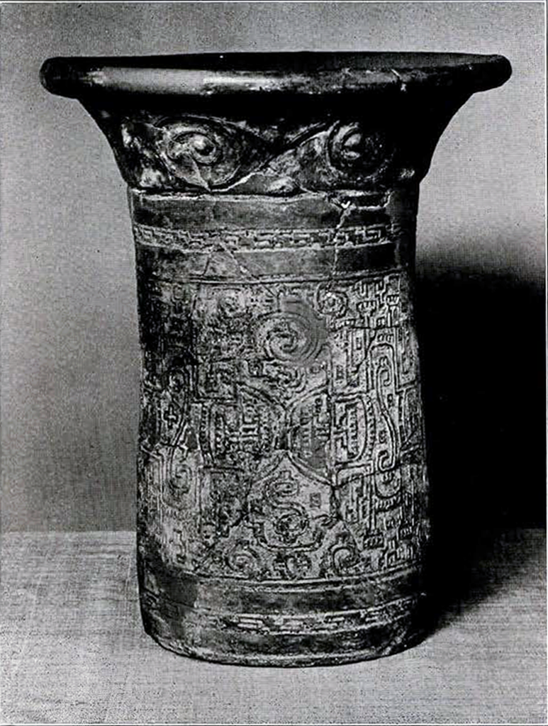 Tall open urn with detailed carvings