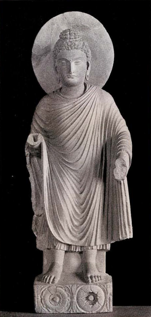 Figure of standing Gandharan Buddha with hands broken off and round halo behind the head