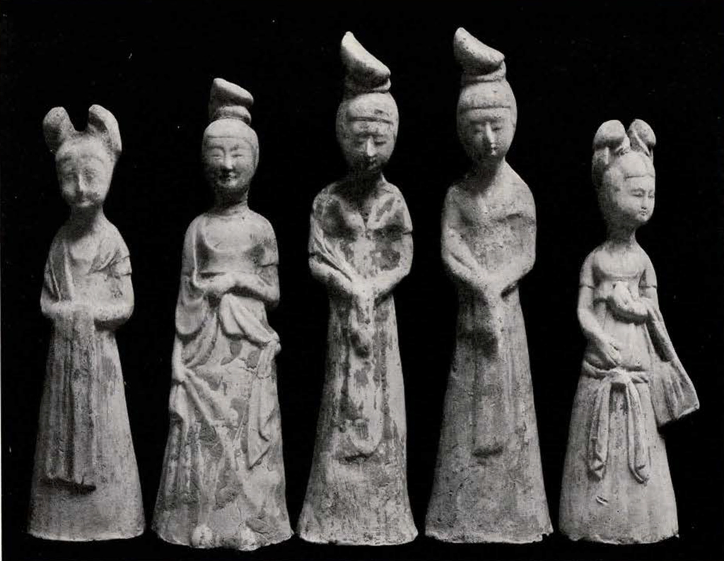 five figurines of standing women in various clothes and positions