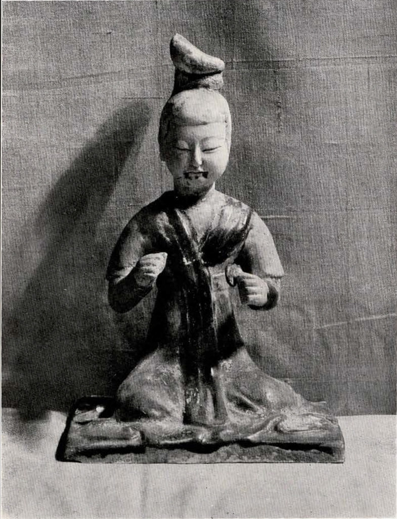 figurine of a seated woman playing the cymbals