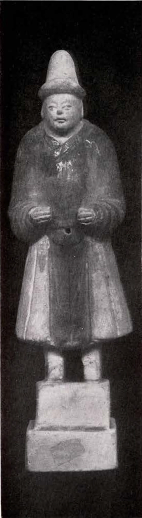 figurine of a standing man with a conical hat