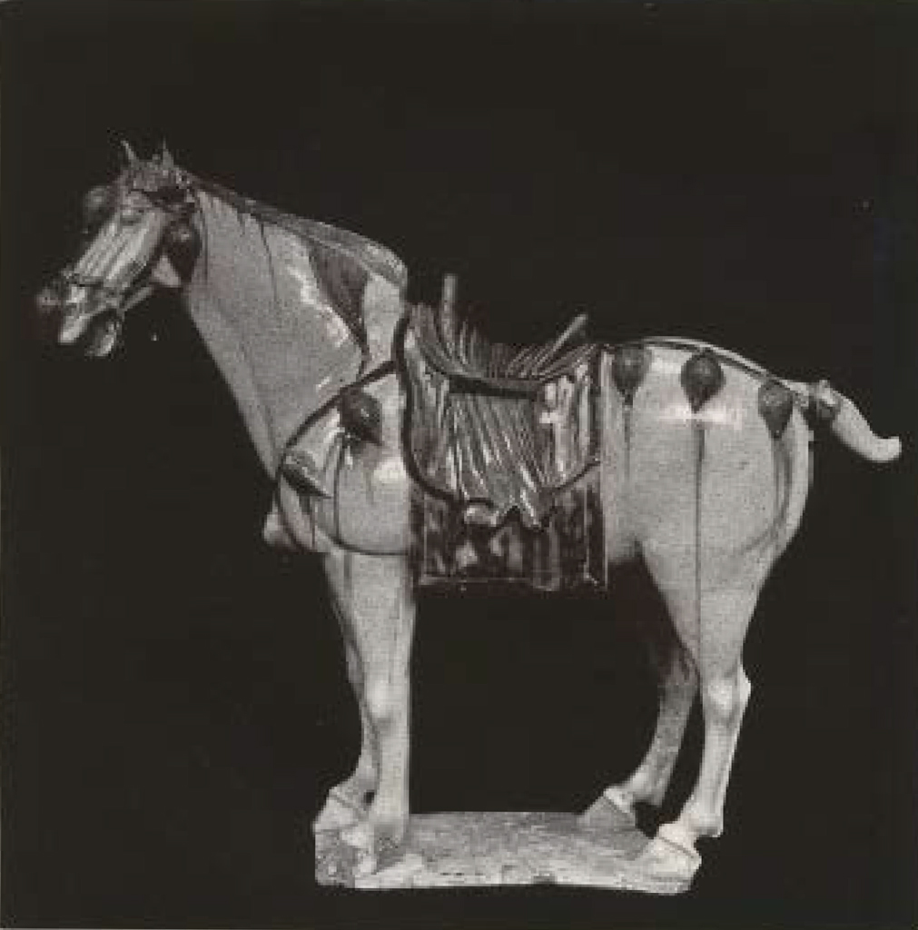 Glazed clay standing horse figure with saddle