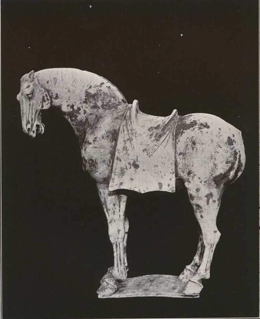 Unglazed clay standing horse figure with saddle but no mane or tail