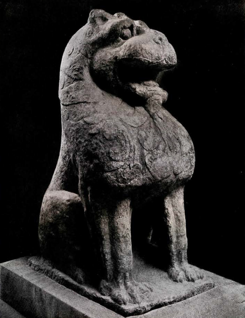 A seated stone lion with its mouth open