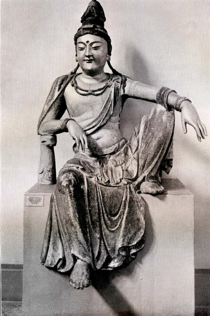 Wooden statue of Guanyin in the royal ease pose with bare chest and draped skirts