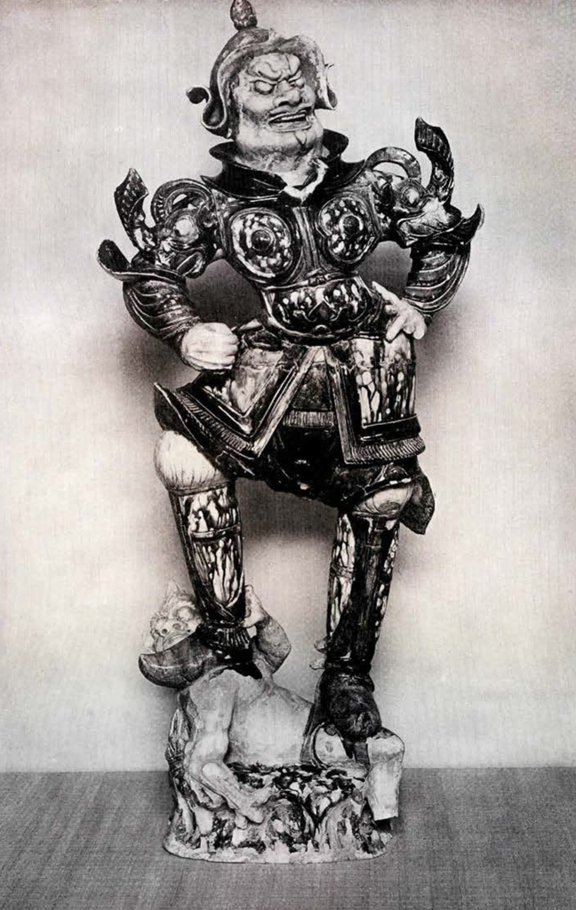 Pottery figurine of a warrior guardian king wearing ornate armor and standing on/crushing a demon beneath his feet
