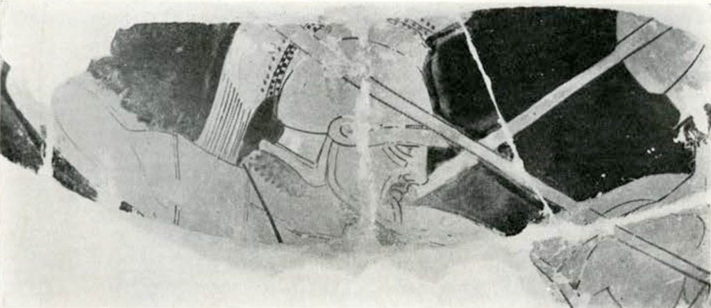 Close up of fragmented area from loutrophoros, showing a warriors head and shoulders, wearing a crested helmet and holding a spear