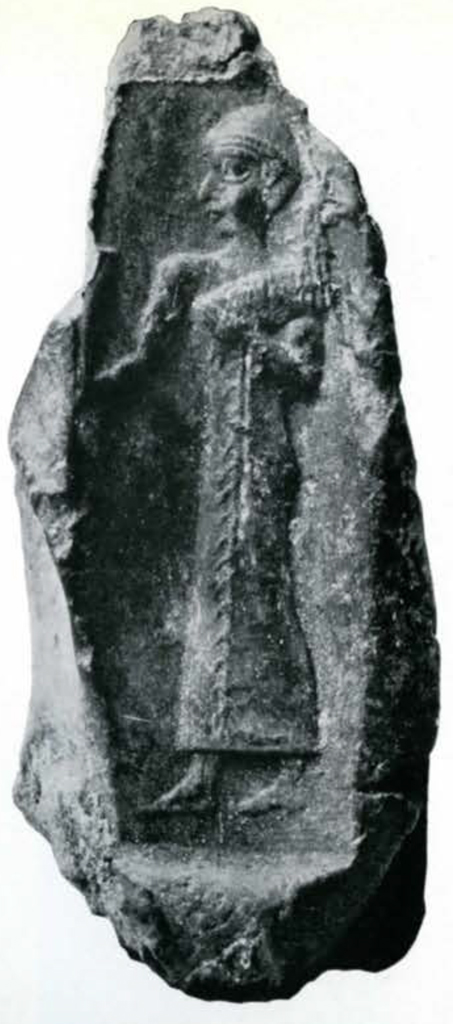 A seal impression of a standing figure holding something in its left arm