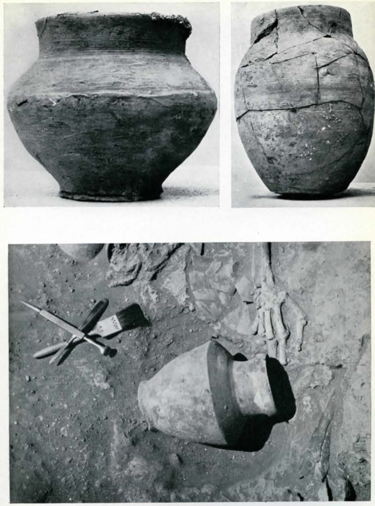 Two jars or pots, one of which is fragmented and pieced together, and a pot next to hand and tools in the ground