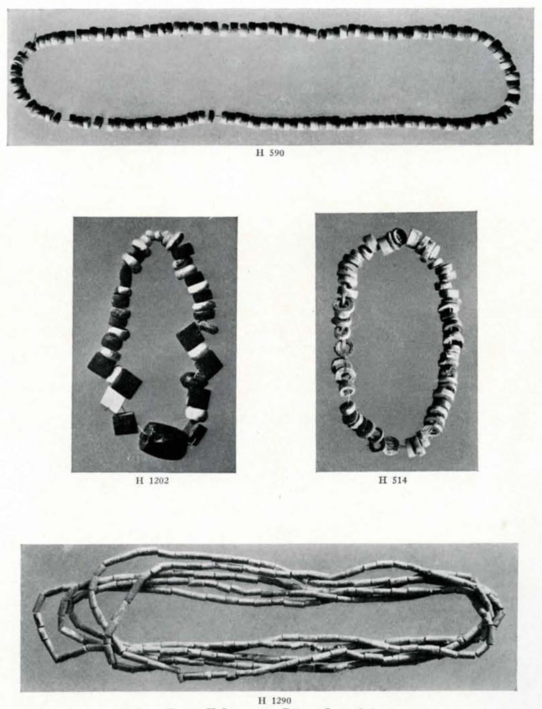 Several strands of beads, one with square beads, two with flat circle beads, and some with long cylindrical beads
