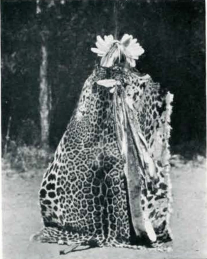 Man wearing a jaguar pelt cape showing the fur pattern