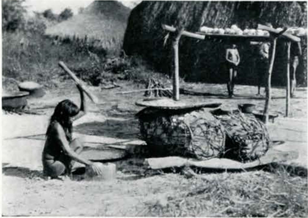 A woman sitting on the ground pounding