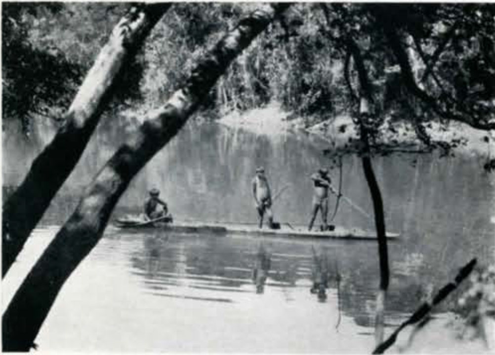 Three people standing on a boat floating down the river, one with bow drawn and pointed at the water