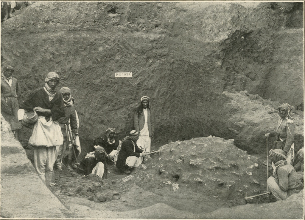 A group of men cleaning a dome in the dirt