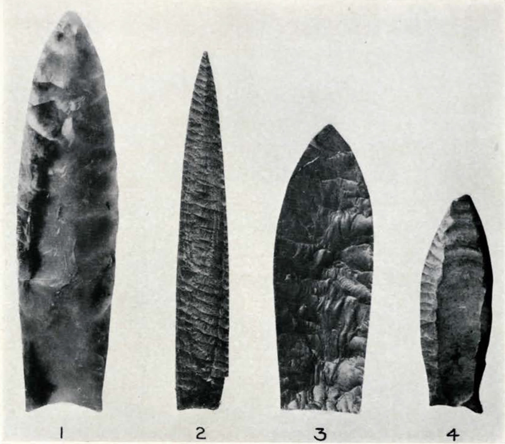 four long carved stone spear points