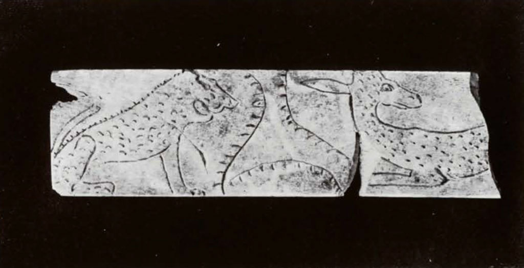 Pieces of inlay showing a stylized lion and gazelle 