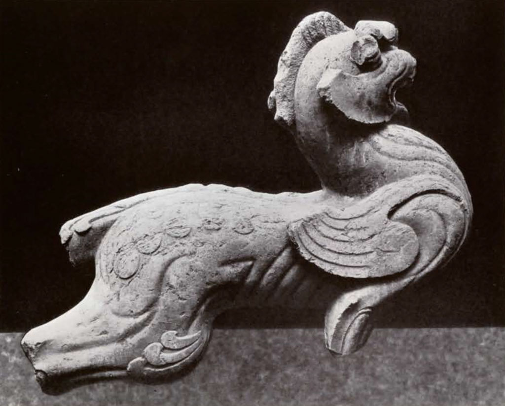Giant stone winged lion statue with one horn, legs and tail missing