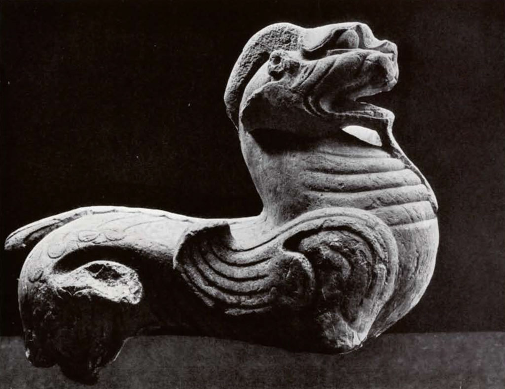 Giant stone winged lion statue with two horns, legs missing