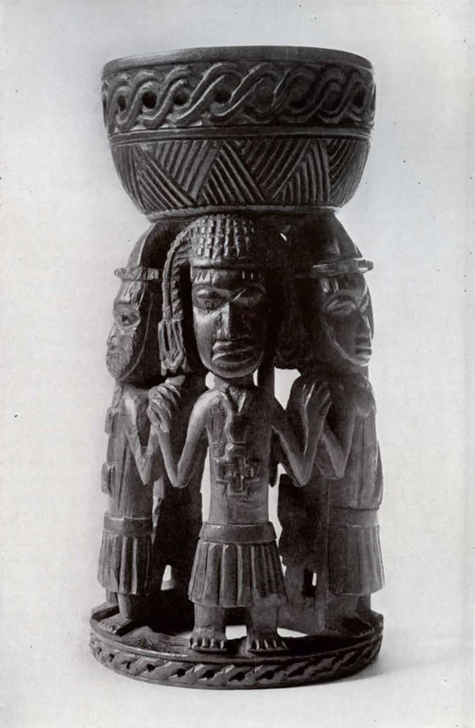 Shallow cup supported by five standing figures in a circle, one of which wears a catfish headdress and cross