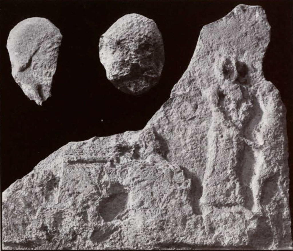 Pieces of a stela, two heads and a libation scene