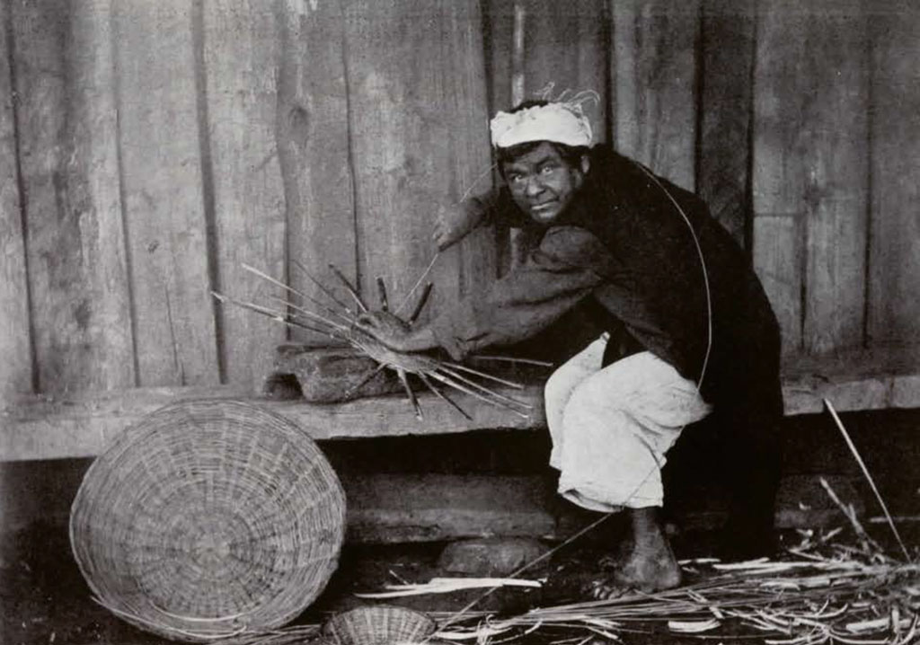 A man weaving a basket