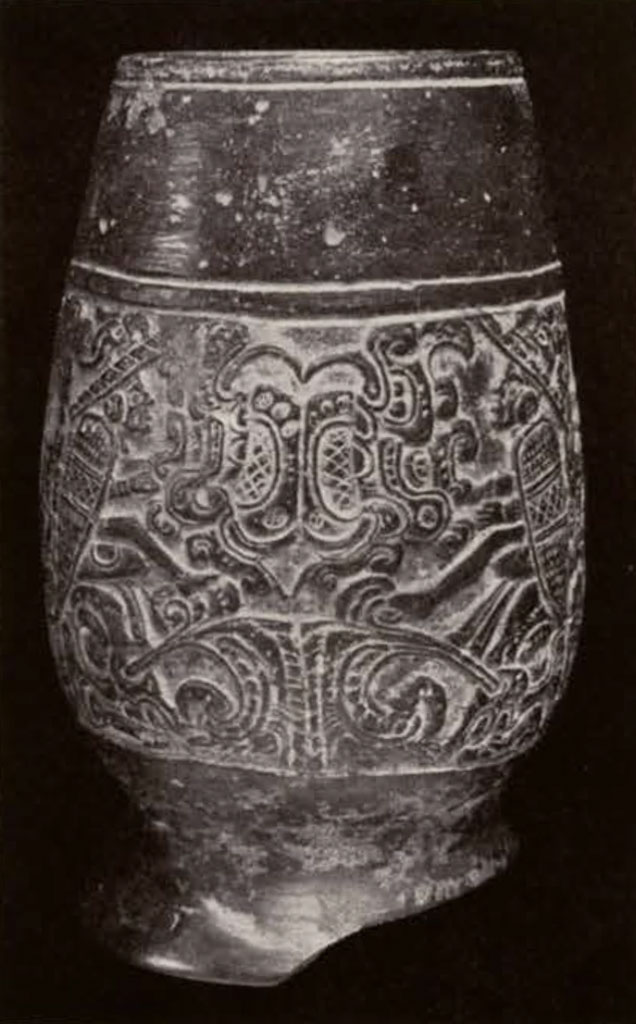A vase with carved swirling designs